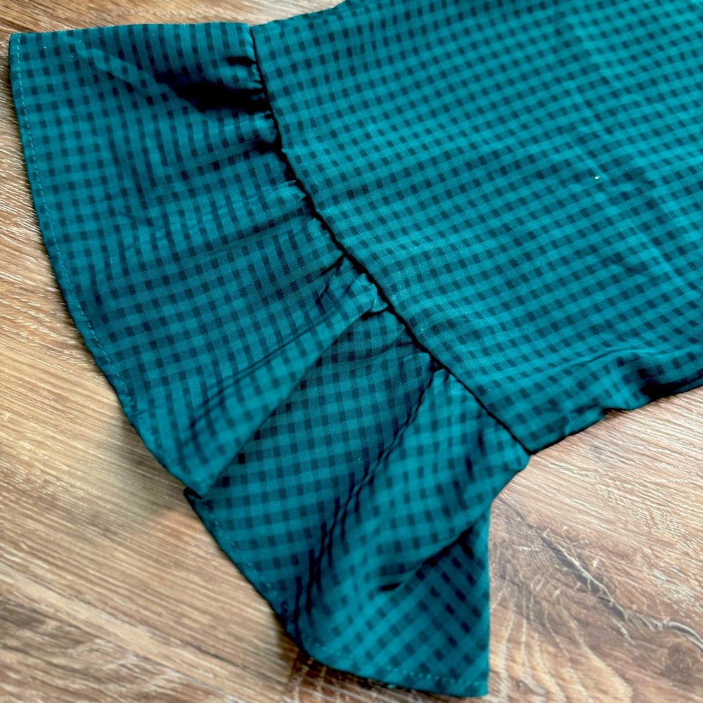 Woman’s small green blouse.
